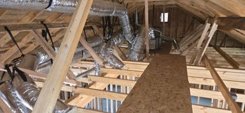 A wooden structure with a lot of pipes coming out of it.