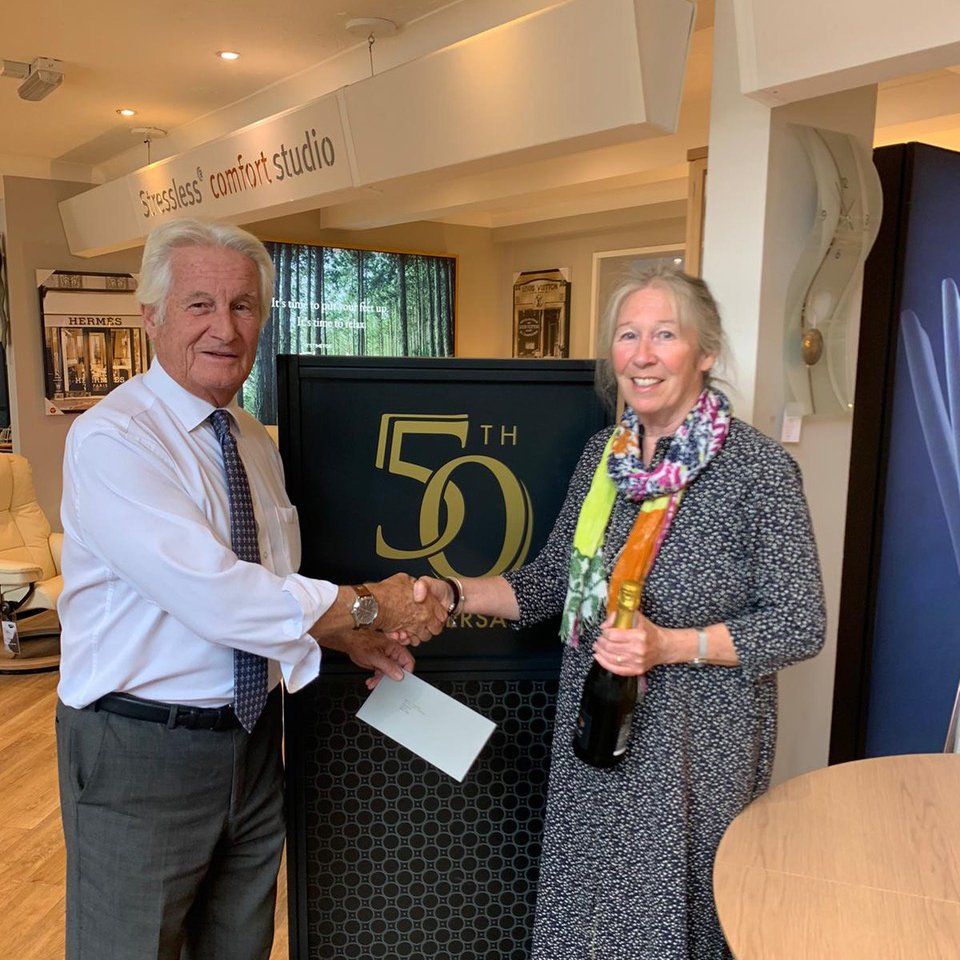 David Phipp presenting the winner of the 50th anniversary prize draw with £500 voucher