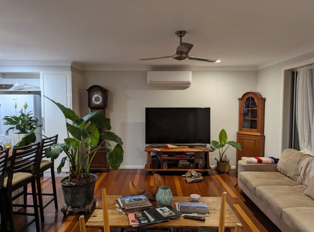 A Living Room With A Couch And A Flat Screen Tv — Able Building and Pest Inspections In Urunga, NSW