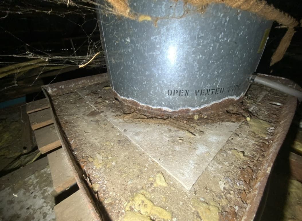 A Metal Bucket Is Sitting On Top Of A Wooden Table — Able Building And Pest Inspections In Nambucca Heads, NSW