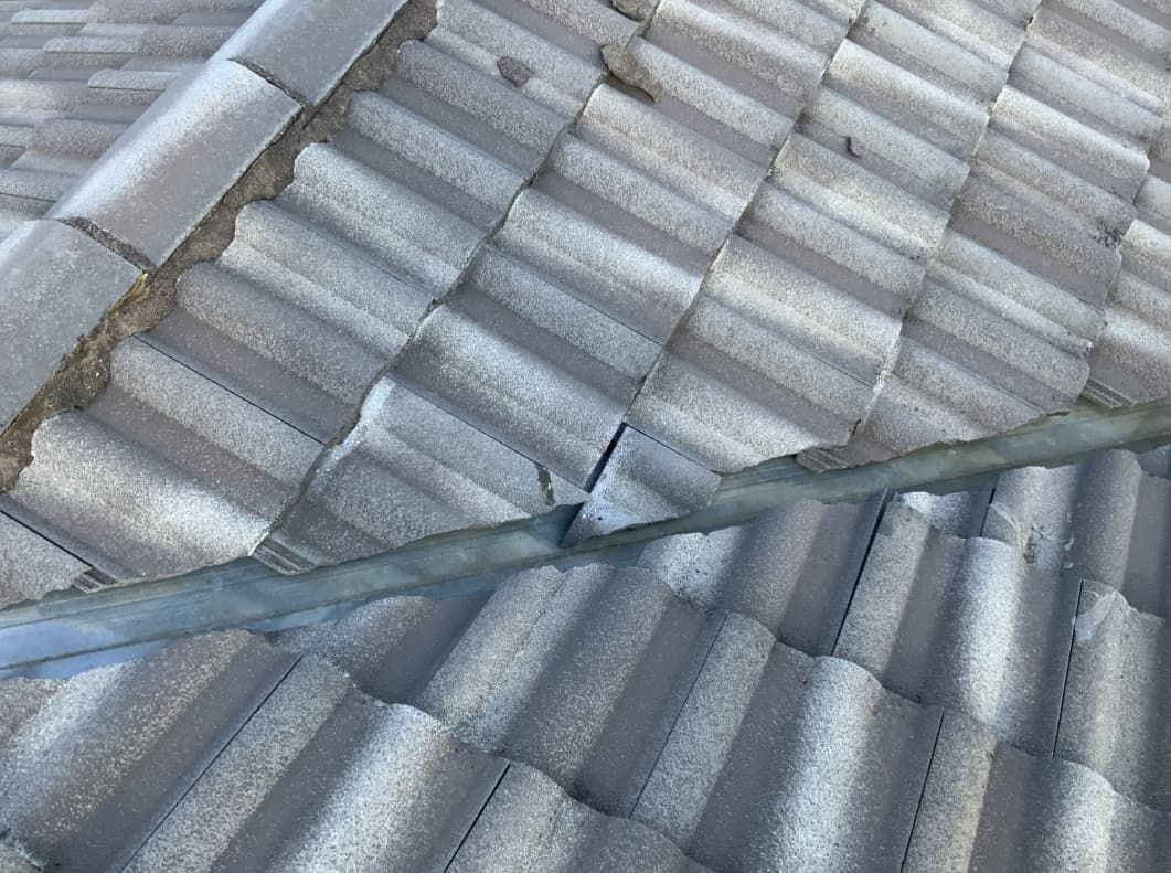A Close Up Of A Tiled Roof With A Metal Pole On It — Able Building and Pest Inspections In Coffs Harbour, NSW