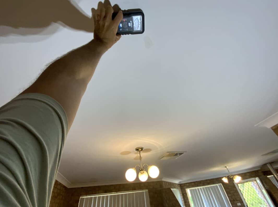 A Person Is Taking A Picture Of A Ceiling With A Cell Phone — Able Building And Pest Inspections In Coffs Harbour, NSW