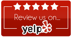 A red sign that says review us on yelp