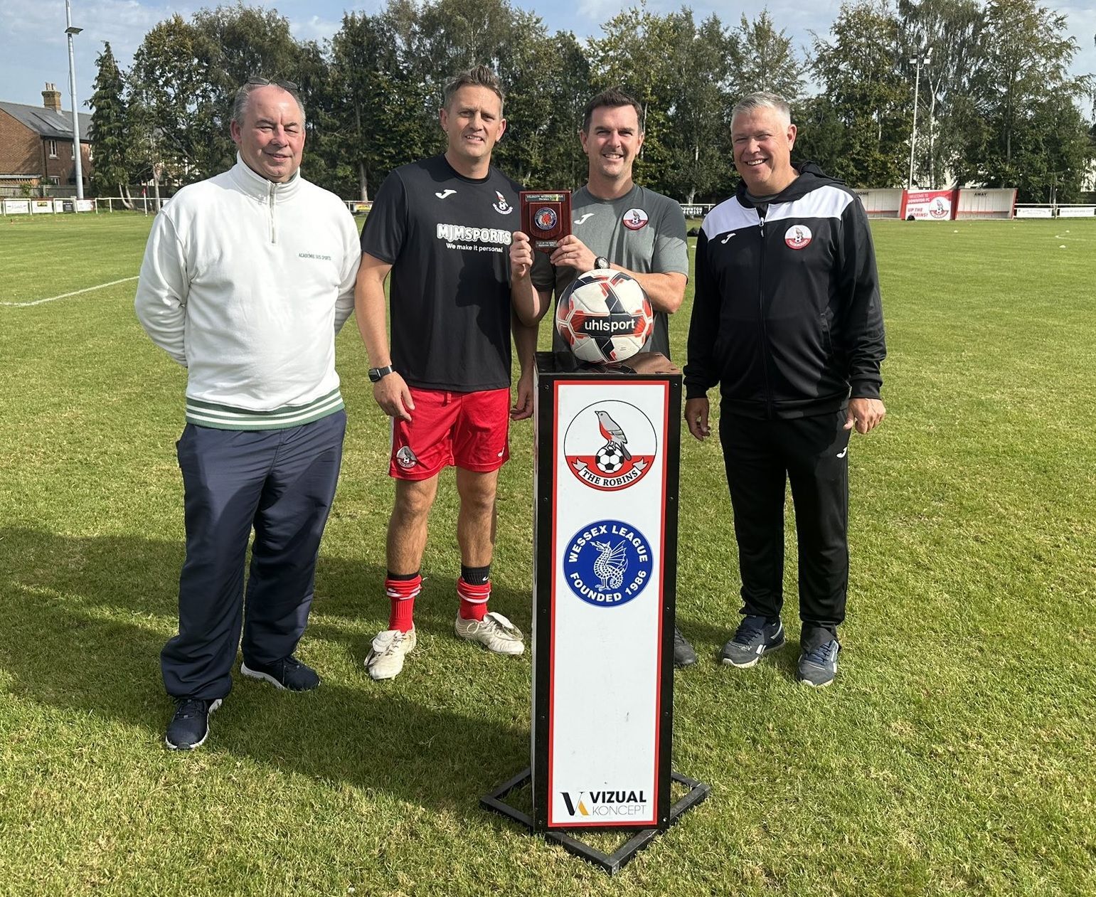 Petersfield Town's Head of Football, Mark Summerhill, receives the Division One Club of the Month for November from Wessex League official, Paul Scoble
