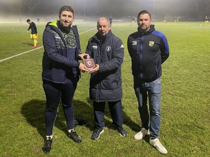 Petersfield Town's Head of Football, Mark Summerhill, receives the Division One Club of the Month for November from Wessex League official, Paul Scoble