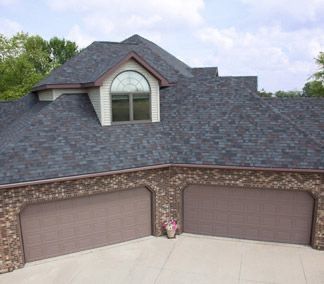 A house with two garage doors and a gray roof