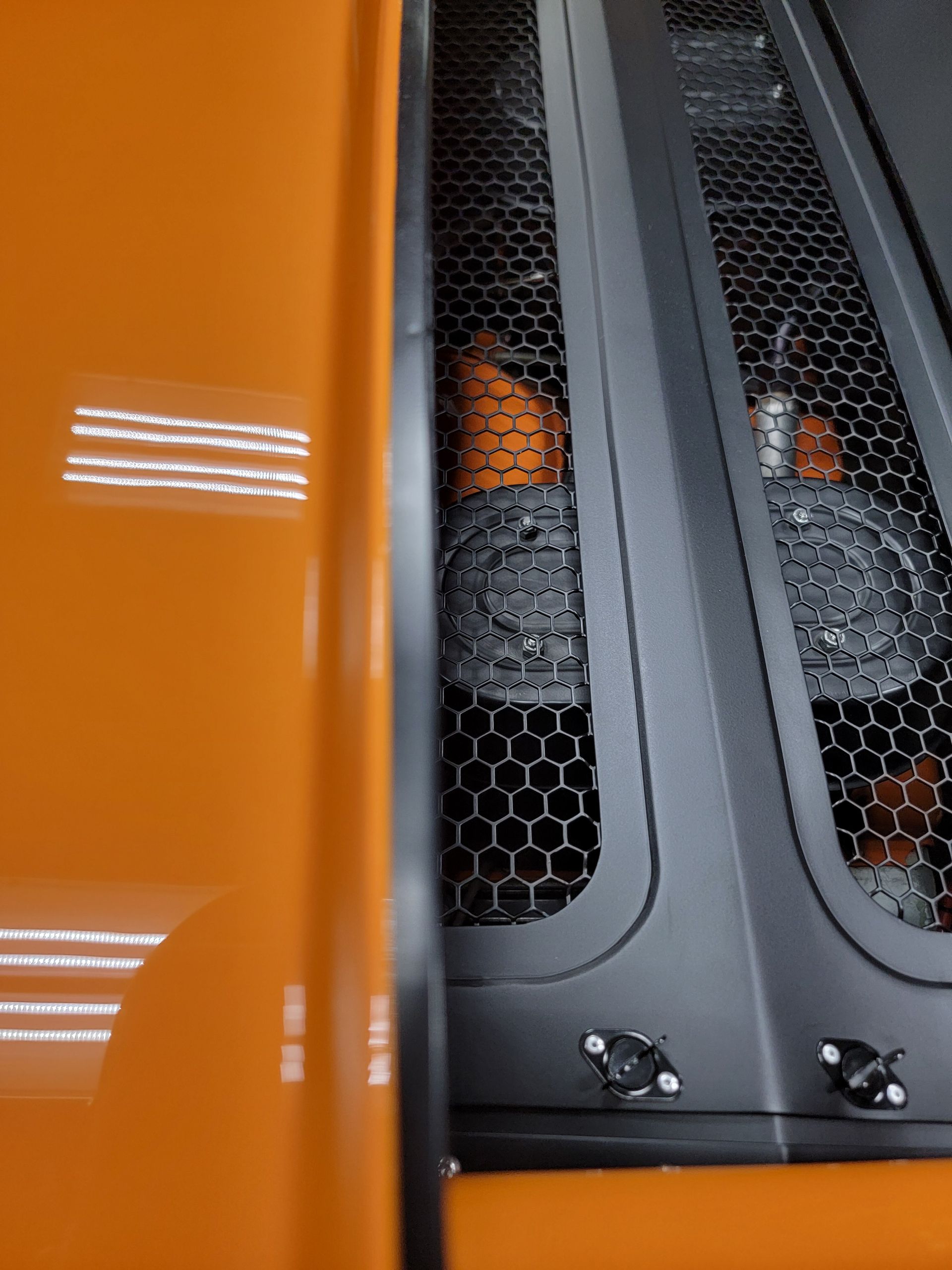 A close up of a computer case with a honeycomb grille