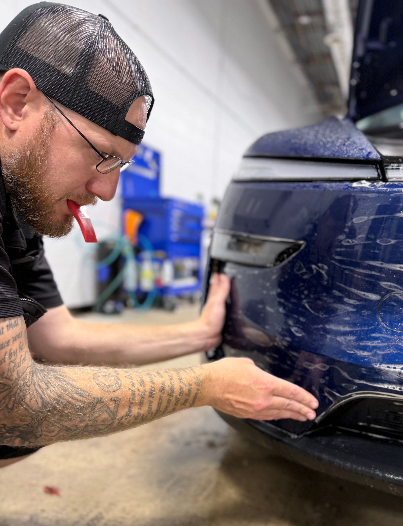 A man is holding a piece of glass with a picture of a cat on it