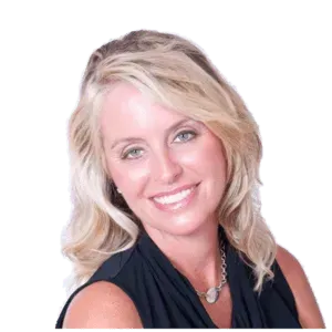 Blonde woman smiling, wearing a black top, and silver necklace.