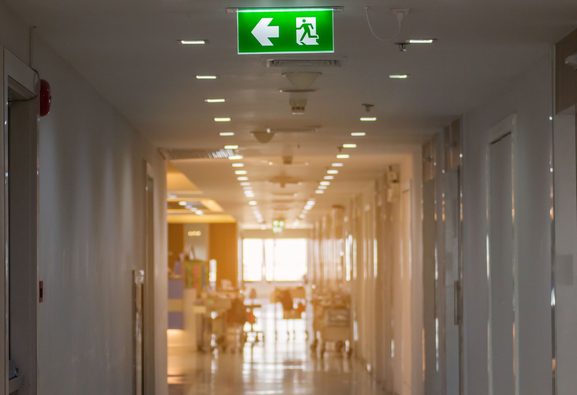 medical facility with an emergency exit sign overhead powered by an emergency lighting inverter