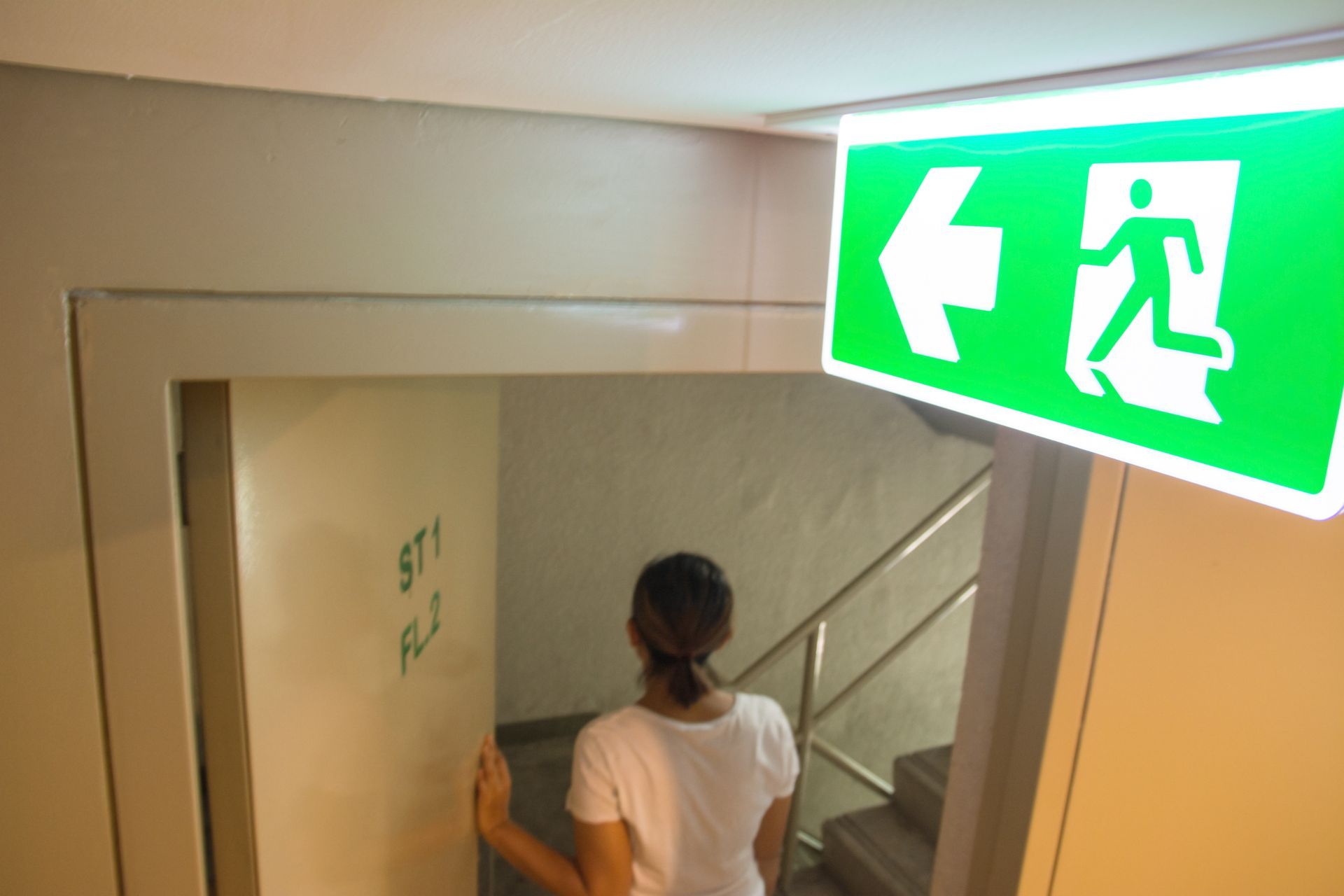 Emergency exit sign lit by an emergency lighting inverter
