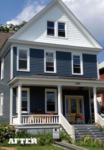 Two-story house with blue siding, white trim, and a yellow front door.