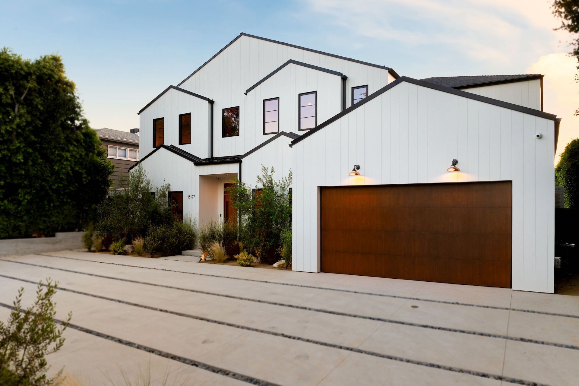 A large white house with a brown garage door