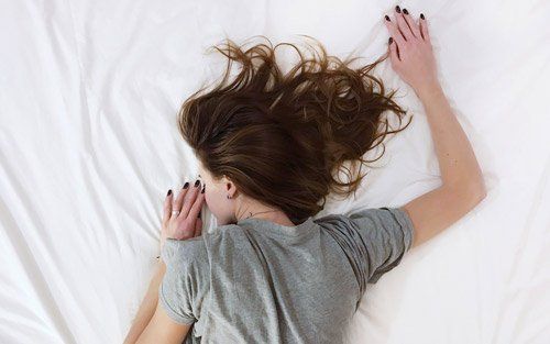 woman laying on mattress