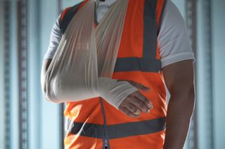 A construction worker with a cast on his arm.