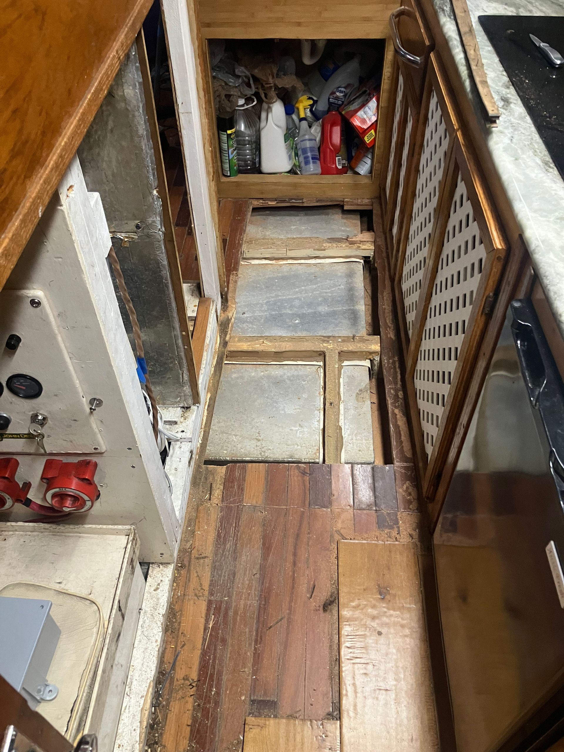 Narrow wooden boat staircase, leading down. Wood planks and metal panels.