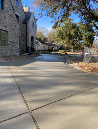 Stone patio with pool and geometric design cover, lit at night.