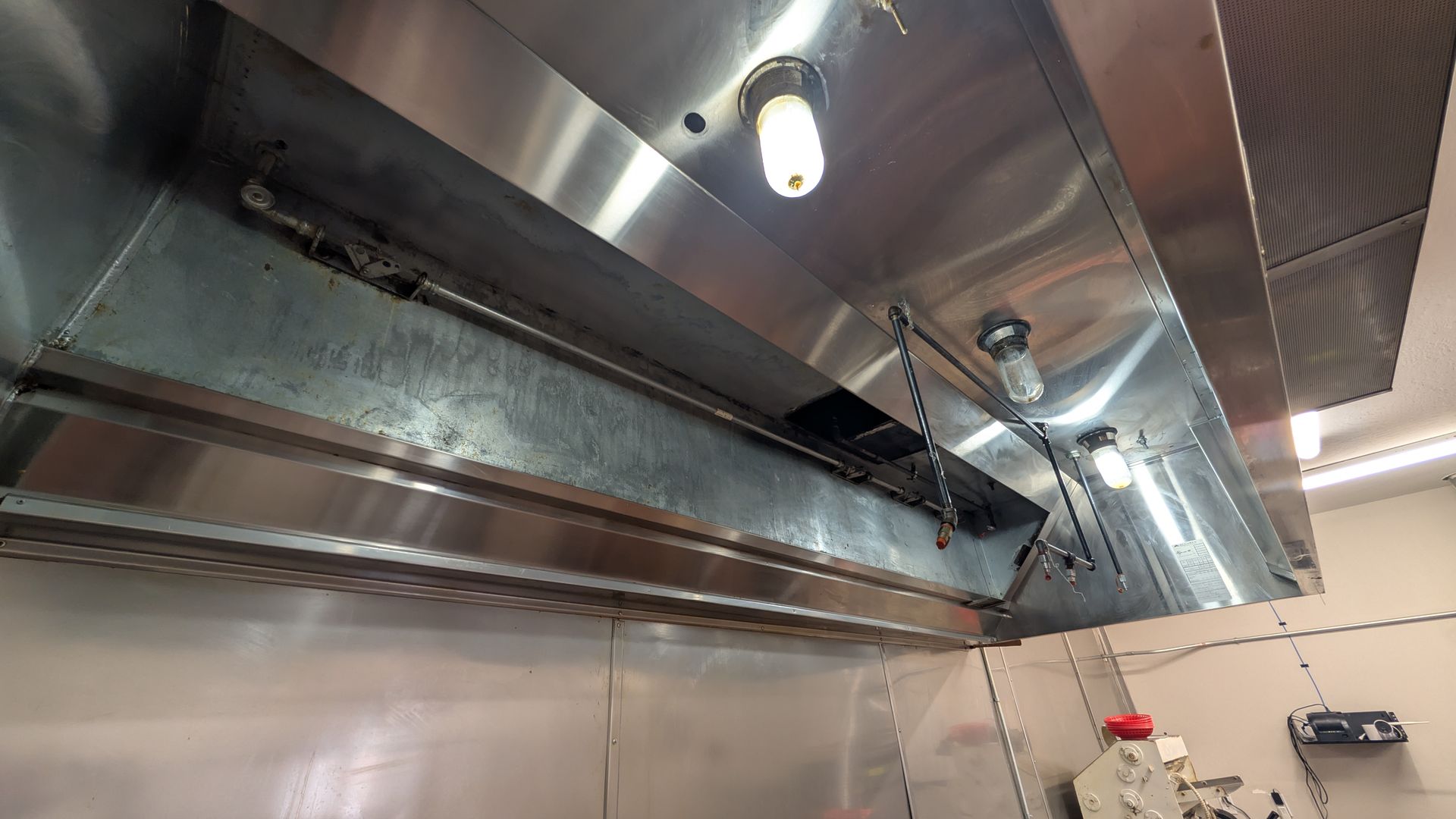 Golden sunset over a grassy plain, viewed from a road with a white line, under a cloudy sky.
