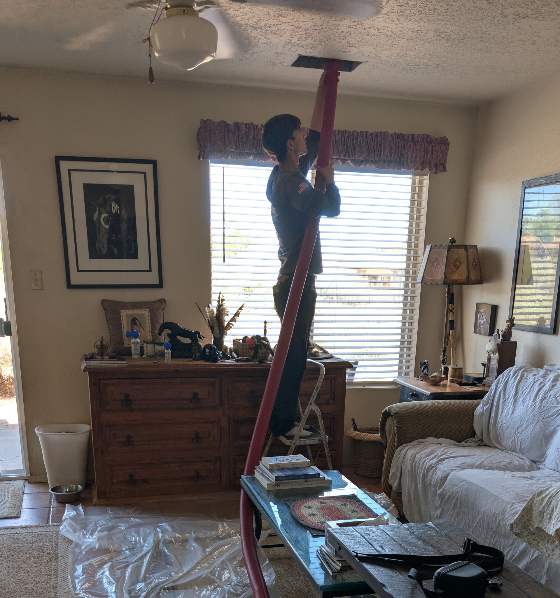 Golden sunset over a grassy plain, viewed from a road with a white line, under a cloudy sky.