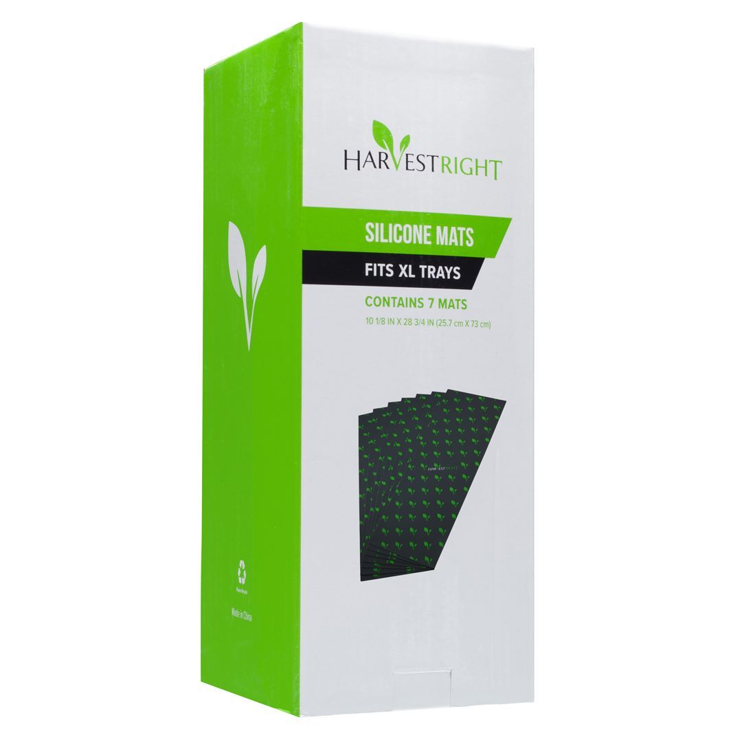 Box of Harvest Right silicone mats. The box is white with green accents, and shows a photo of the dark mats.