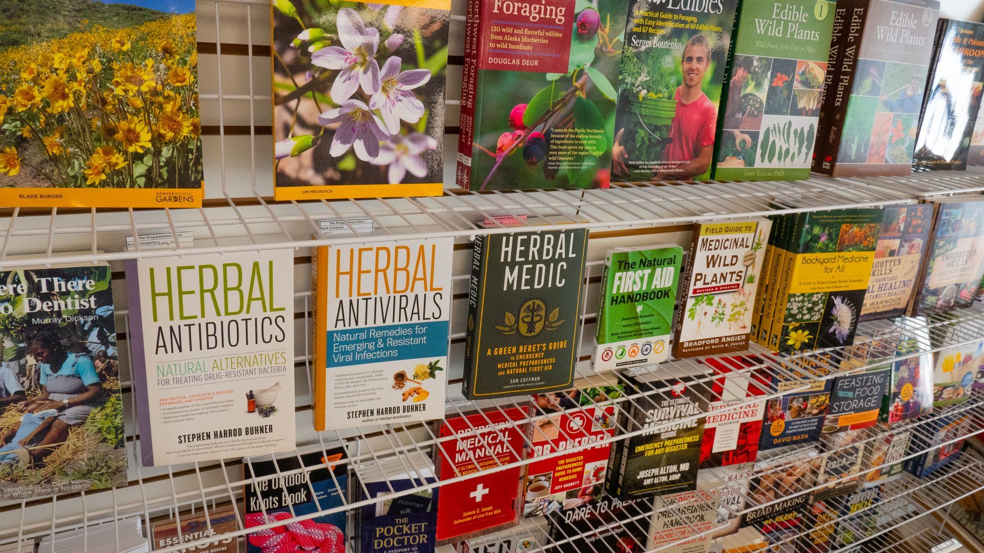 Books on a wire shelf, including titles like 