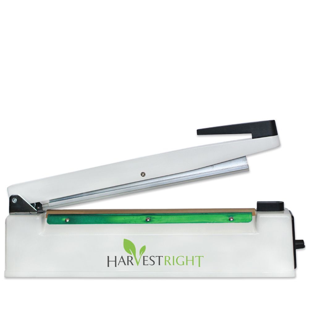 White Harvest Right impulse sealer, handle raised. Green heating element visible.
