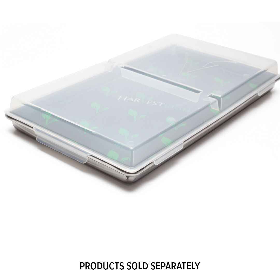 A rectangular aluminum tray with a clear plastic lid. The tray is divided into two sections and has a partially visible green design underneath.