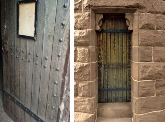 A side-by-side view of two rustic, wooden plank doors reinforced with dark metal bands set into stone masonry.