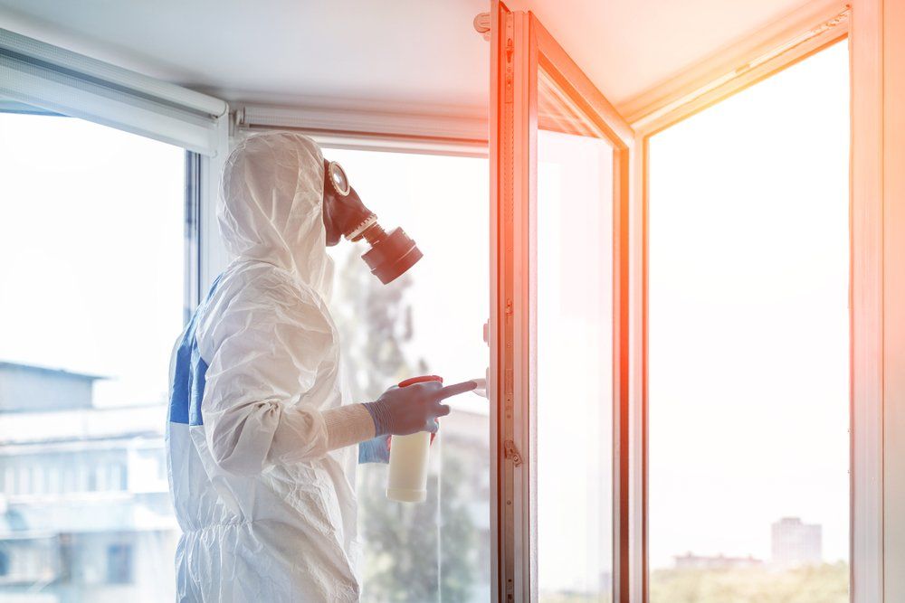 Man Wearing Protective Biological Suit And Gas-Mask While Cleaning — Professional Cleaning In Rockhampton, QLD