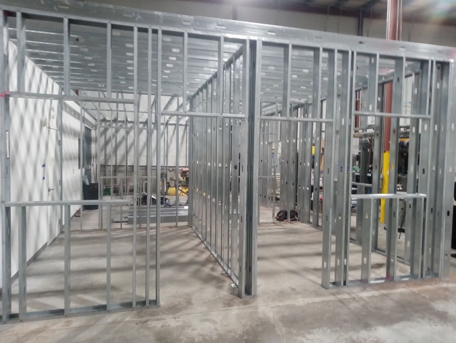 A room with a lot of metal frames on the walls