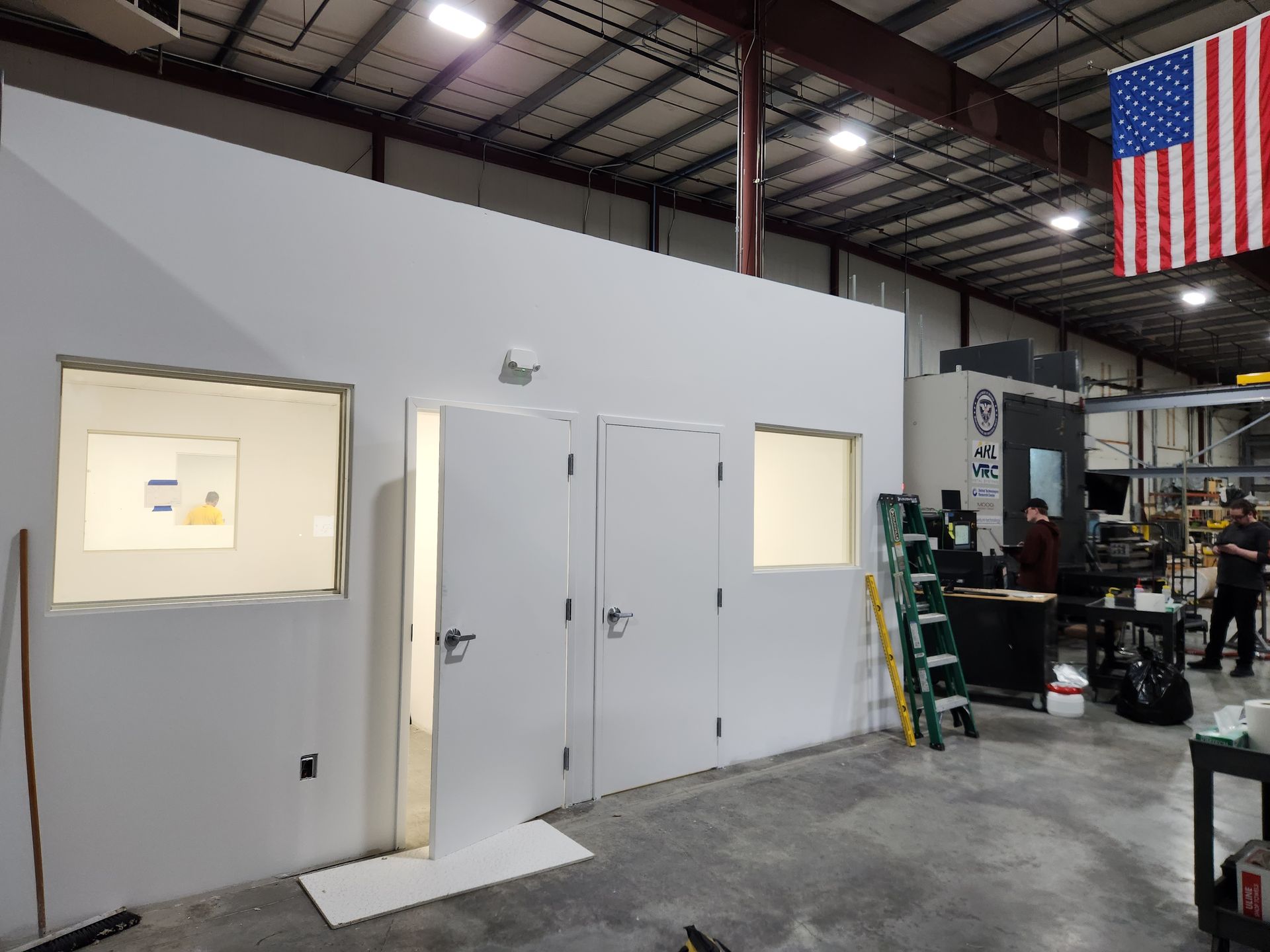 A warehouse with a large american flag hanging from the ceiling
