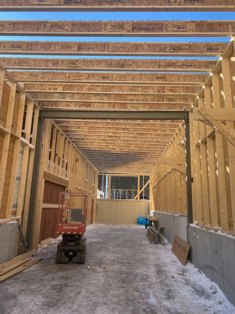 A wooden deck with a white railing and trees in the background.