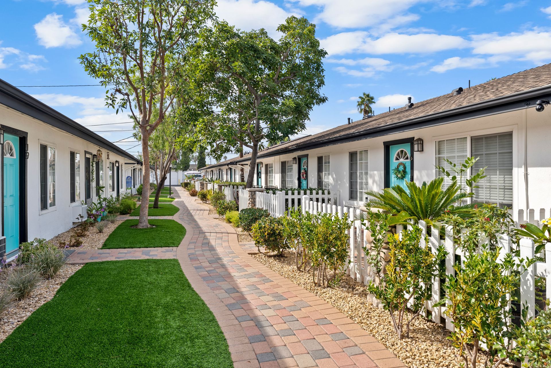 landscaping, tree, and winding path along building