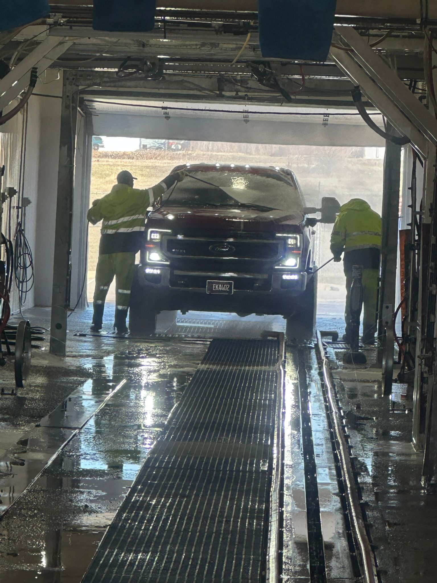 A truck is being washed in a car wash