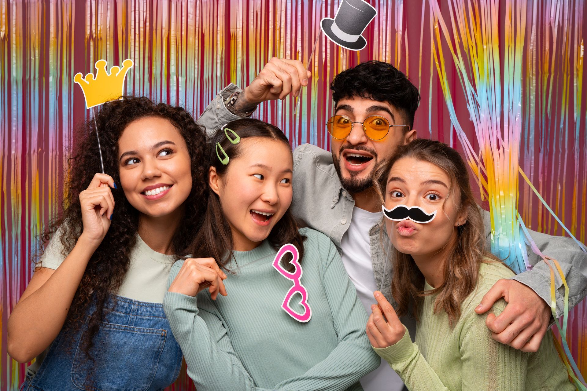 A group of young people are posing for a picture in a photo booth.