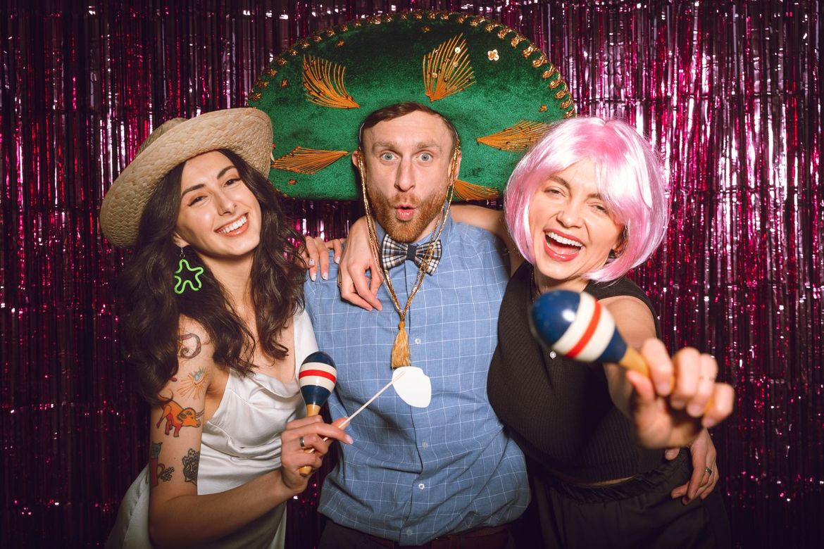 A group of people are posing for a picture in a photo booth.