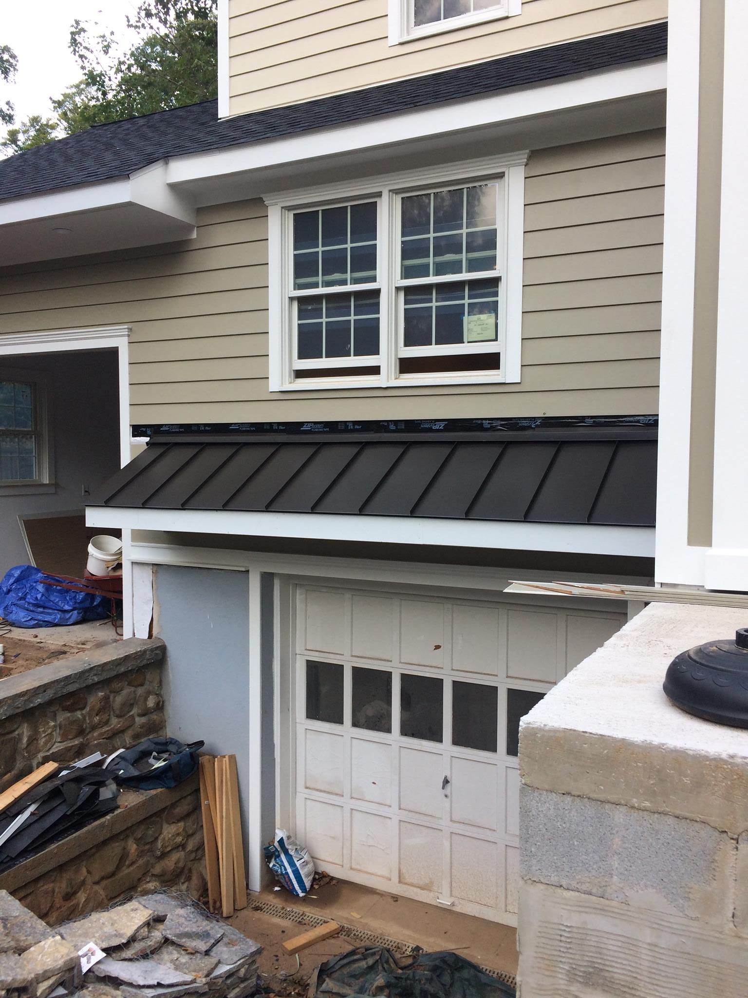 A House With a Black Roof and a White Garage Door - Whitehall, PA - Jimenez Contracting LLC