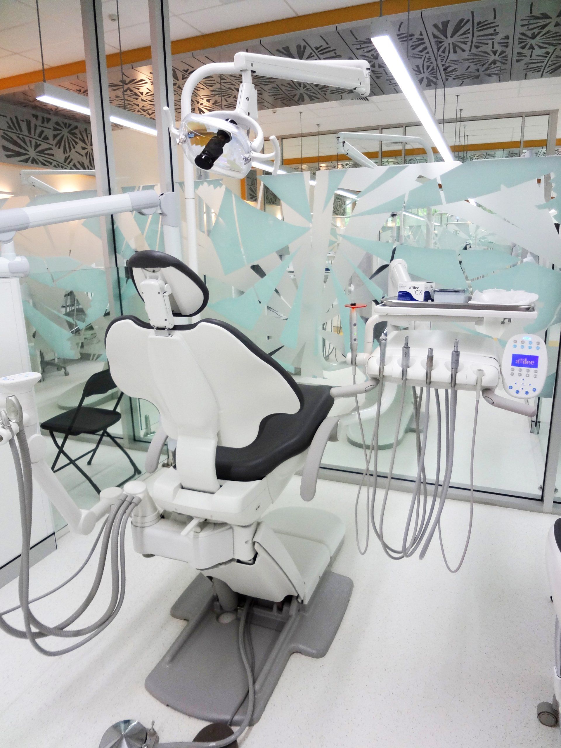 Pretty Young Woman Sitting In Dental Chair — JCU Dental In Smithfield, QLD