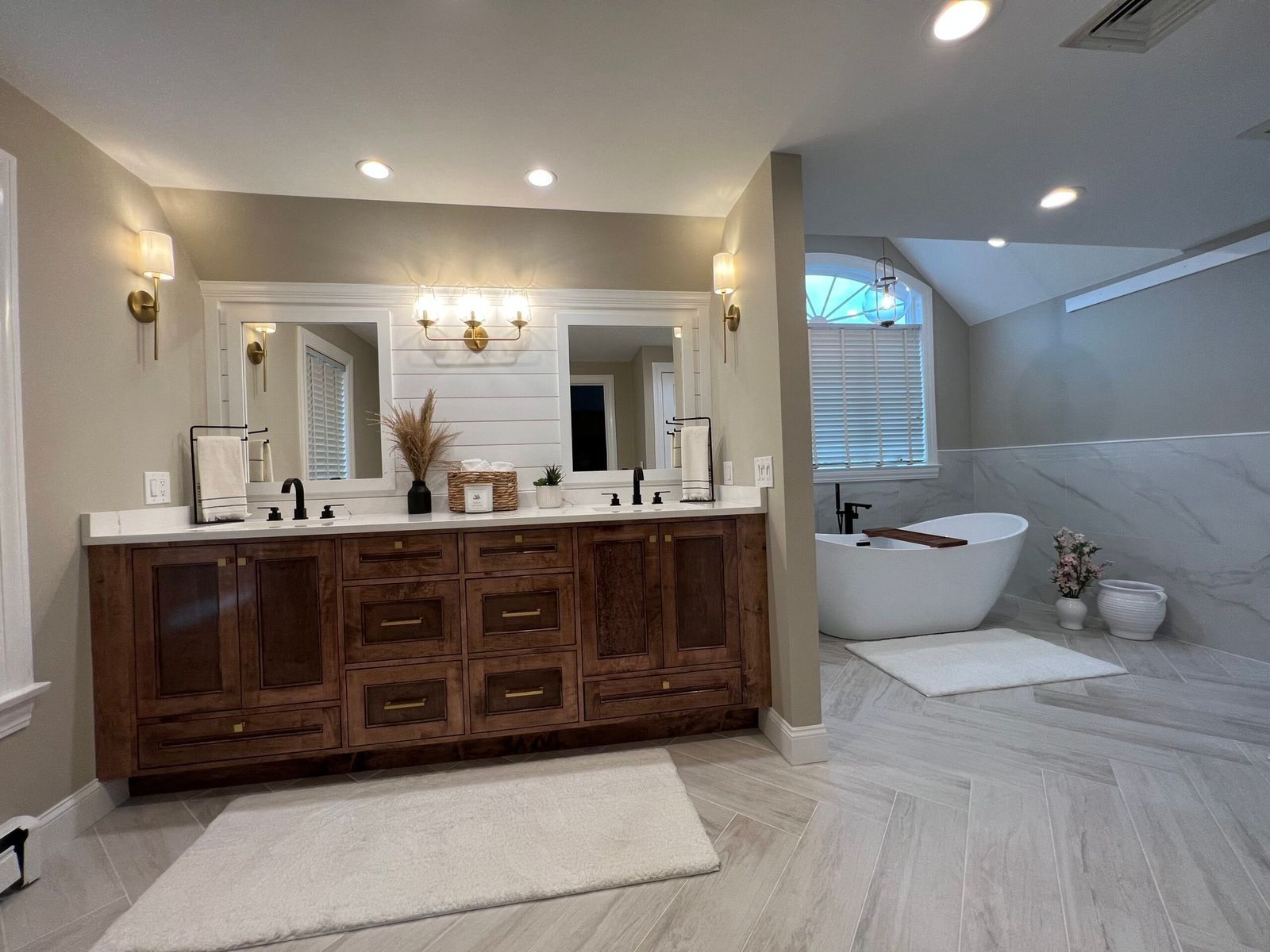 Bathroom with a double vanity, soaking tub, and neutral color scheme.