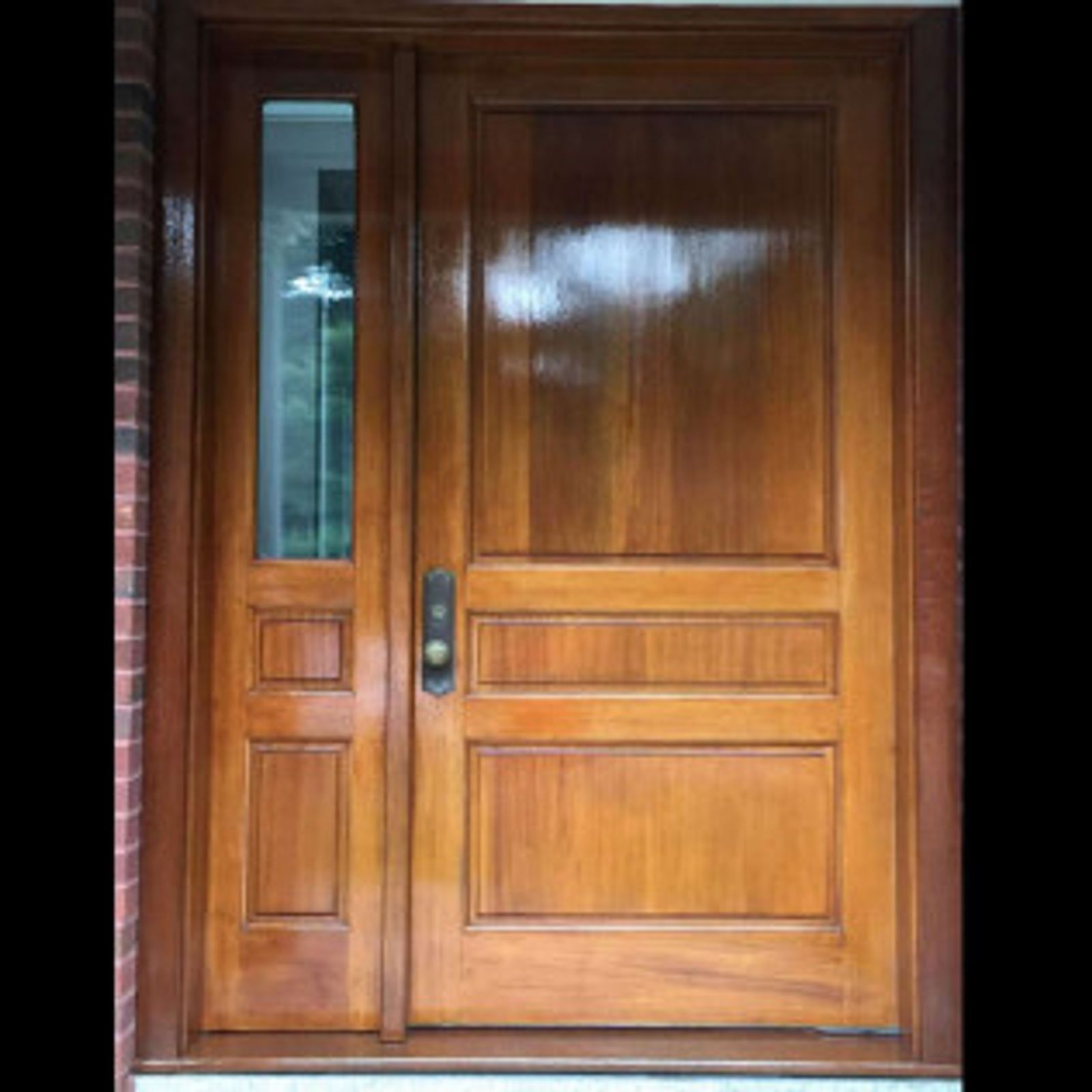 Wooden front door with sidelight, brown stain, polished finish.