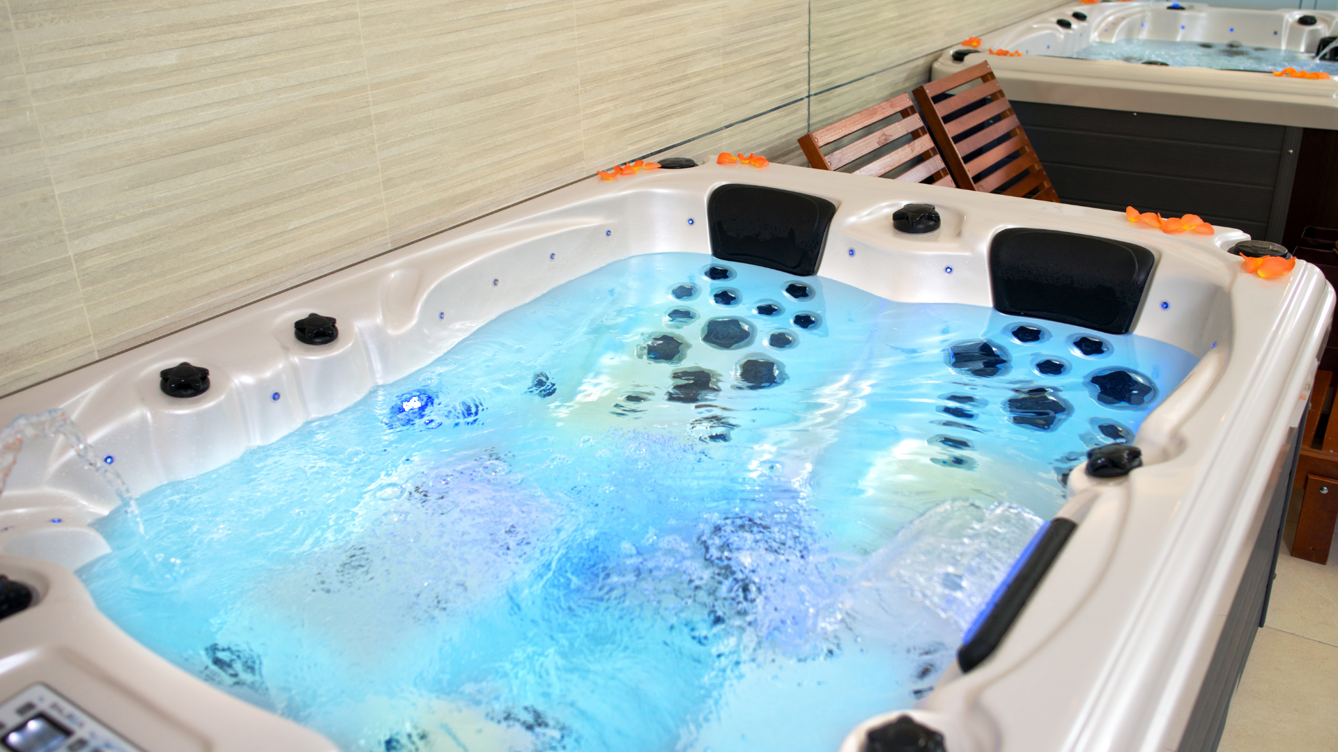 A hot tub is filled with blue water in a room.