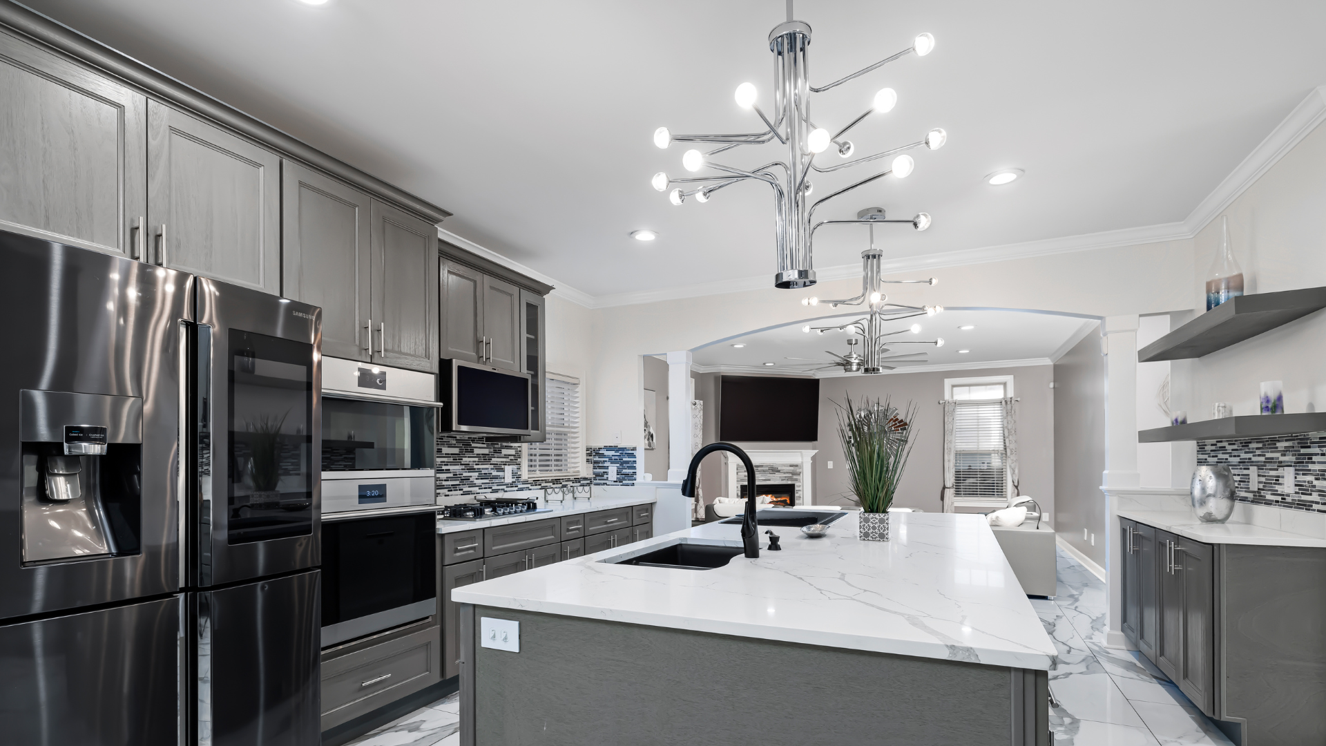 A kitchen with stainless steel appliances and a large island.