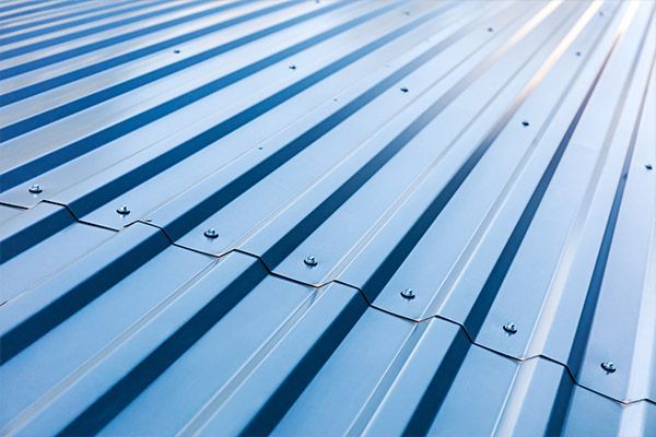 blue through fastened metal roofing with sun reflecting