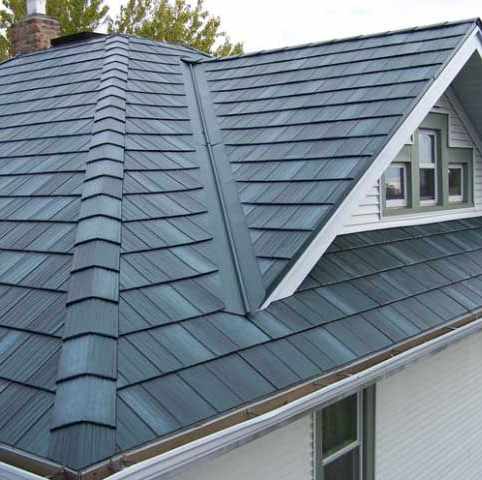 Installer inspecting metal shingle roof with certification badge