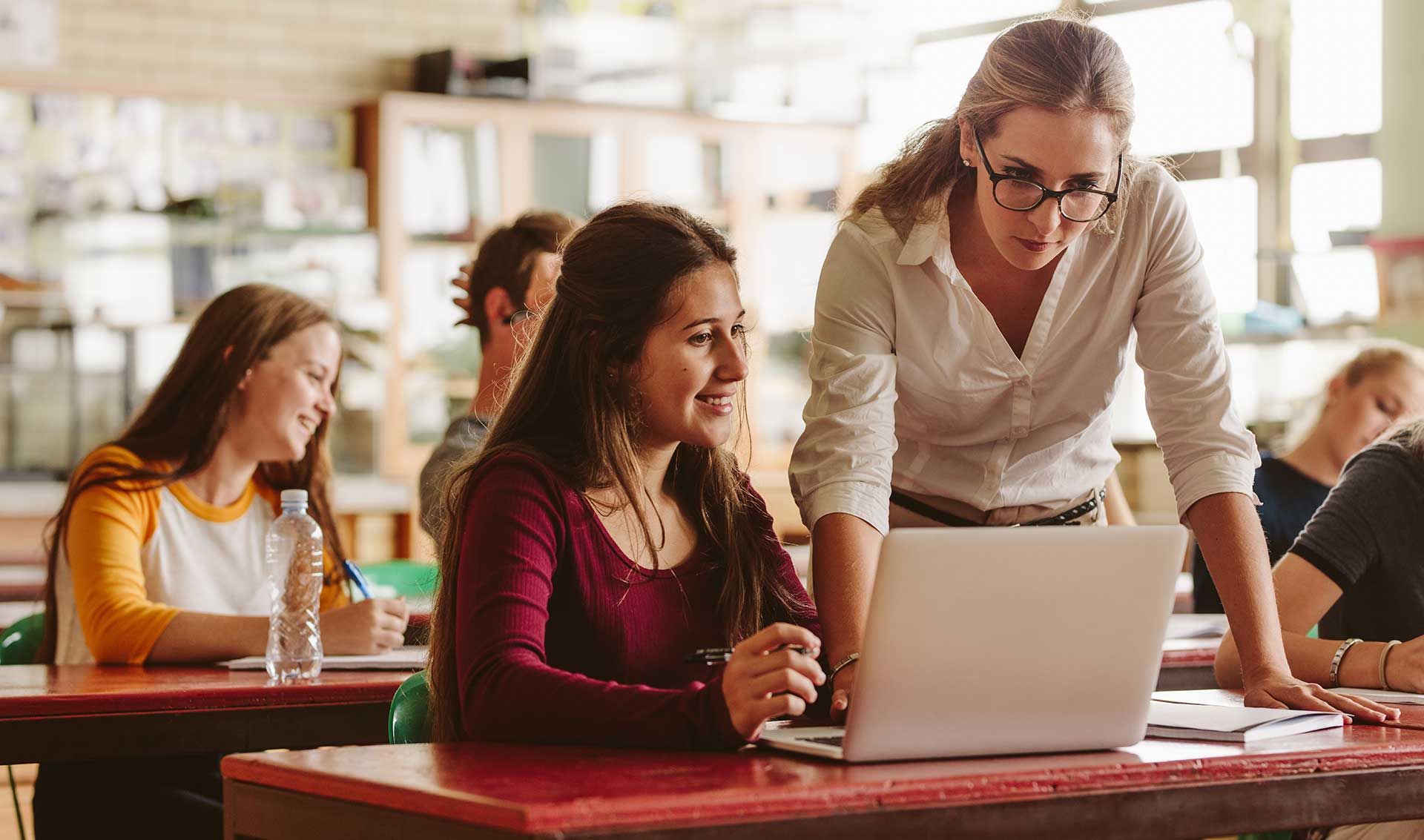 Teacher helping a student during class. 
