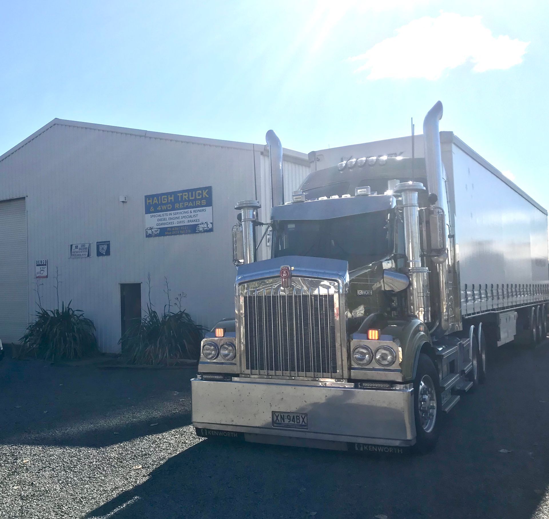 Blue Shipping Container on A Semi-Truck Driving on A Gray Road — Haigh Truck & 4WD Repairs In Orange, NSW