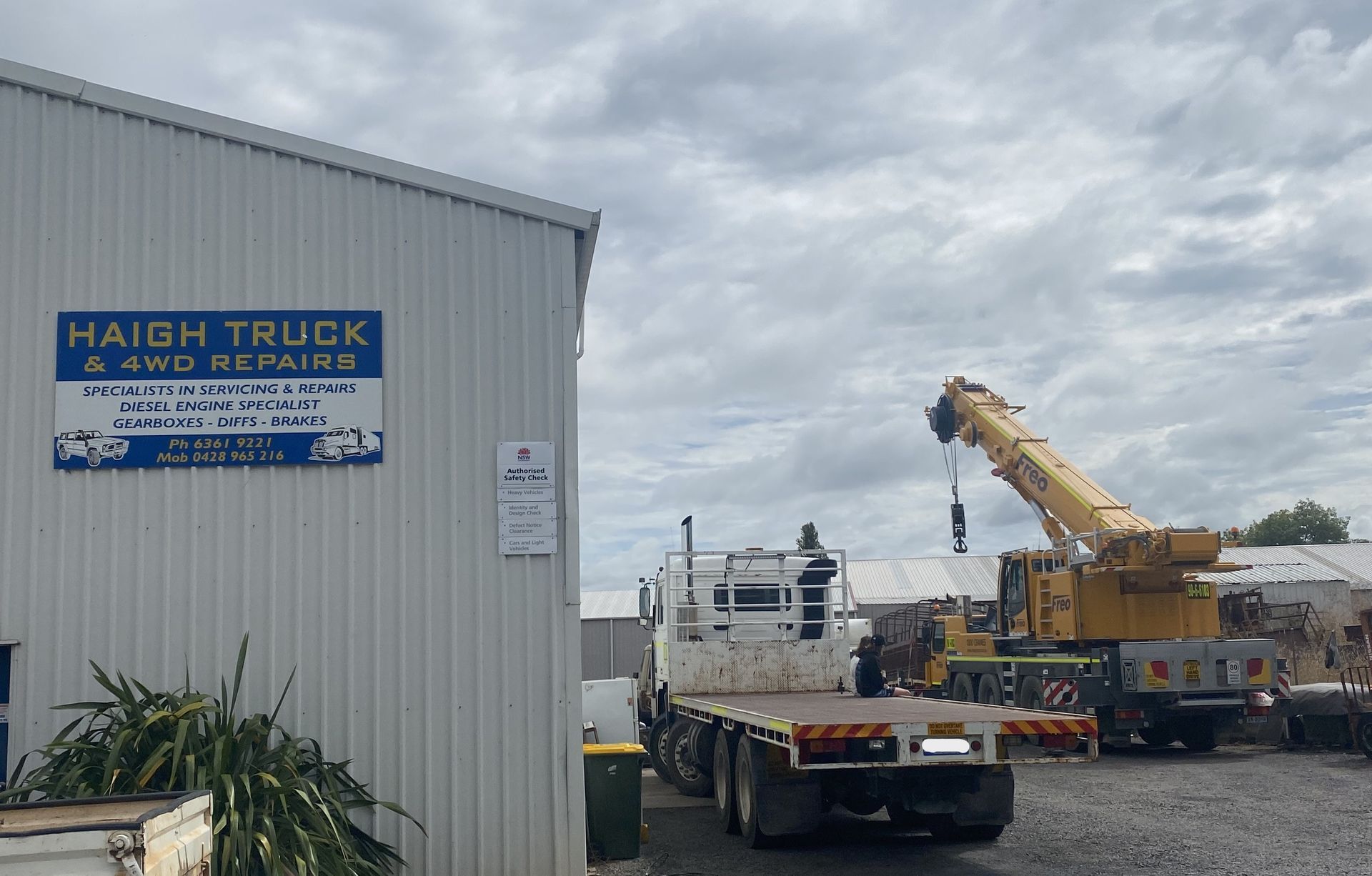 Yellow Industrial Crane on A Paved Surface — Haigh Truck & 4WD Repairs In Orange, NSW