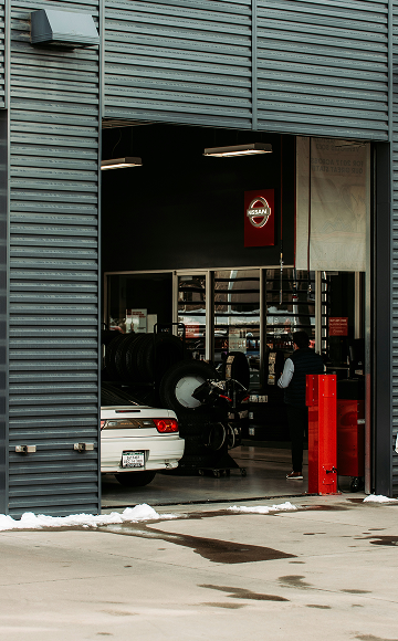 A Car Is Being Serviced at A Nissan Garage with The Logo Visible — Haigh Truck & 4WD Repairs In Orange, NSW