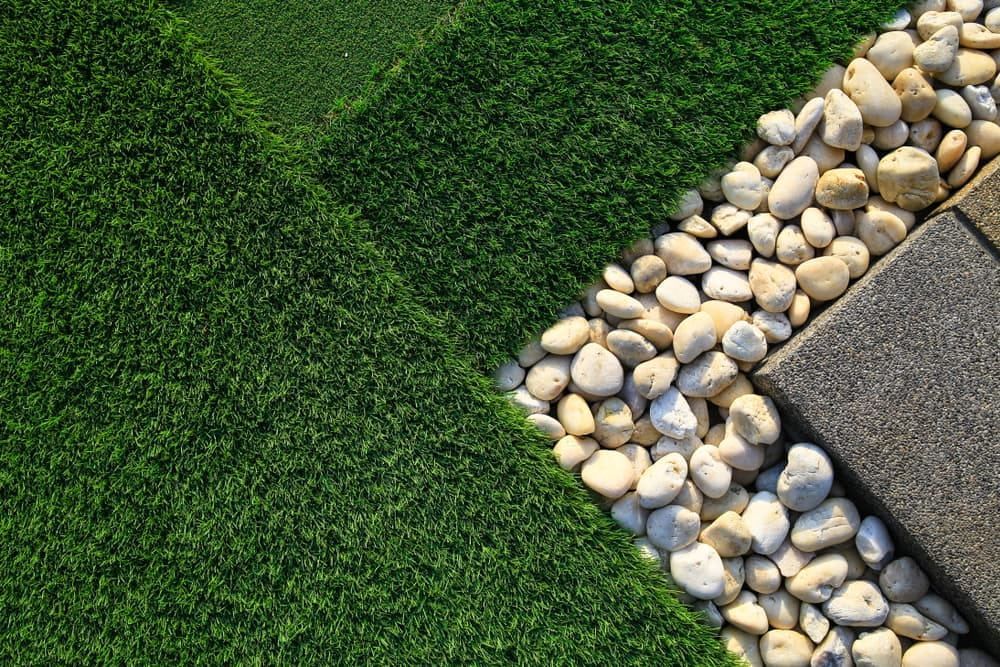 Green Artificial Turf, White Pebbles, and Gray Paving Stones in a Garden — The Soil Yard in Delacombe, VIC