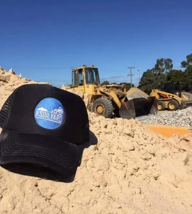Black Cap With Logo in Foreground — The Soil Yard in Delacombe, VIC